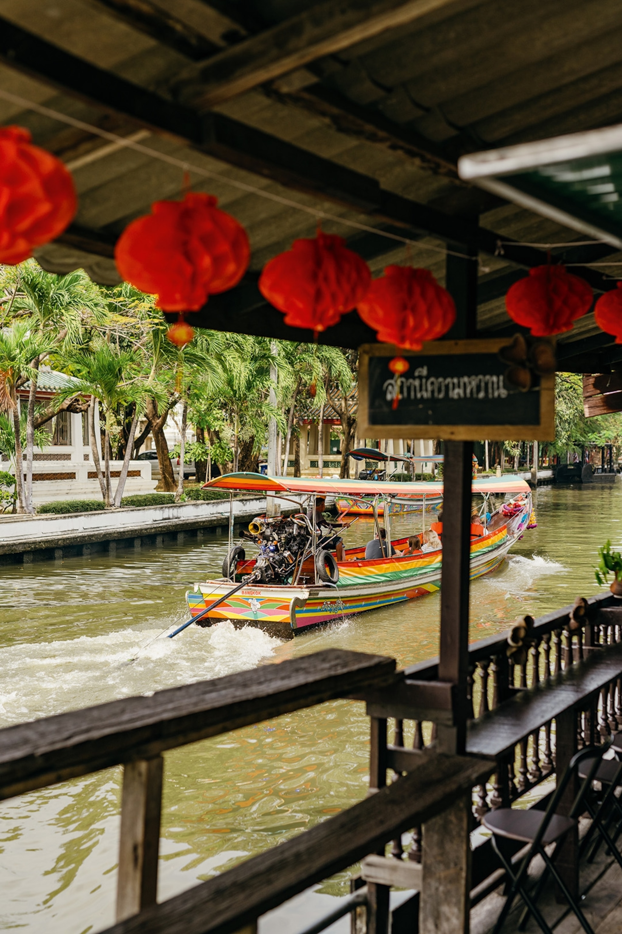 A colourful sightseeing boat floats along the river in western Bangkok.