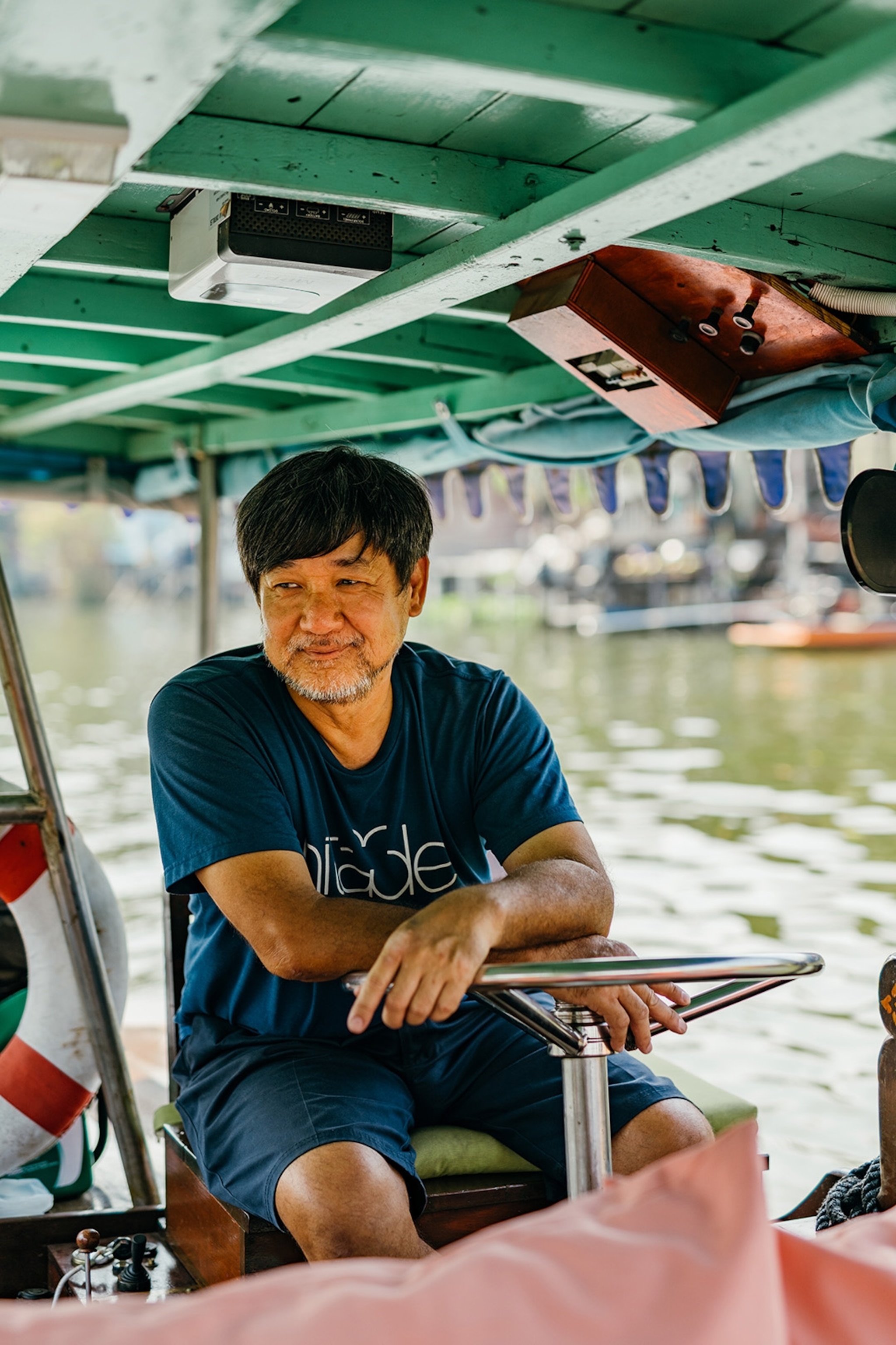 Captain Tai on his electric boat in Bangkok