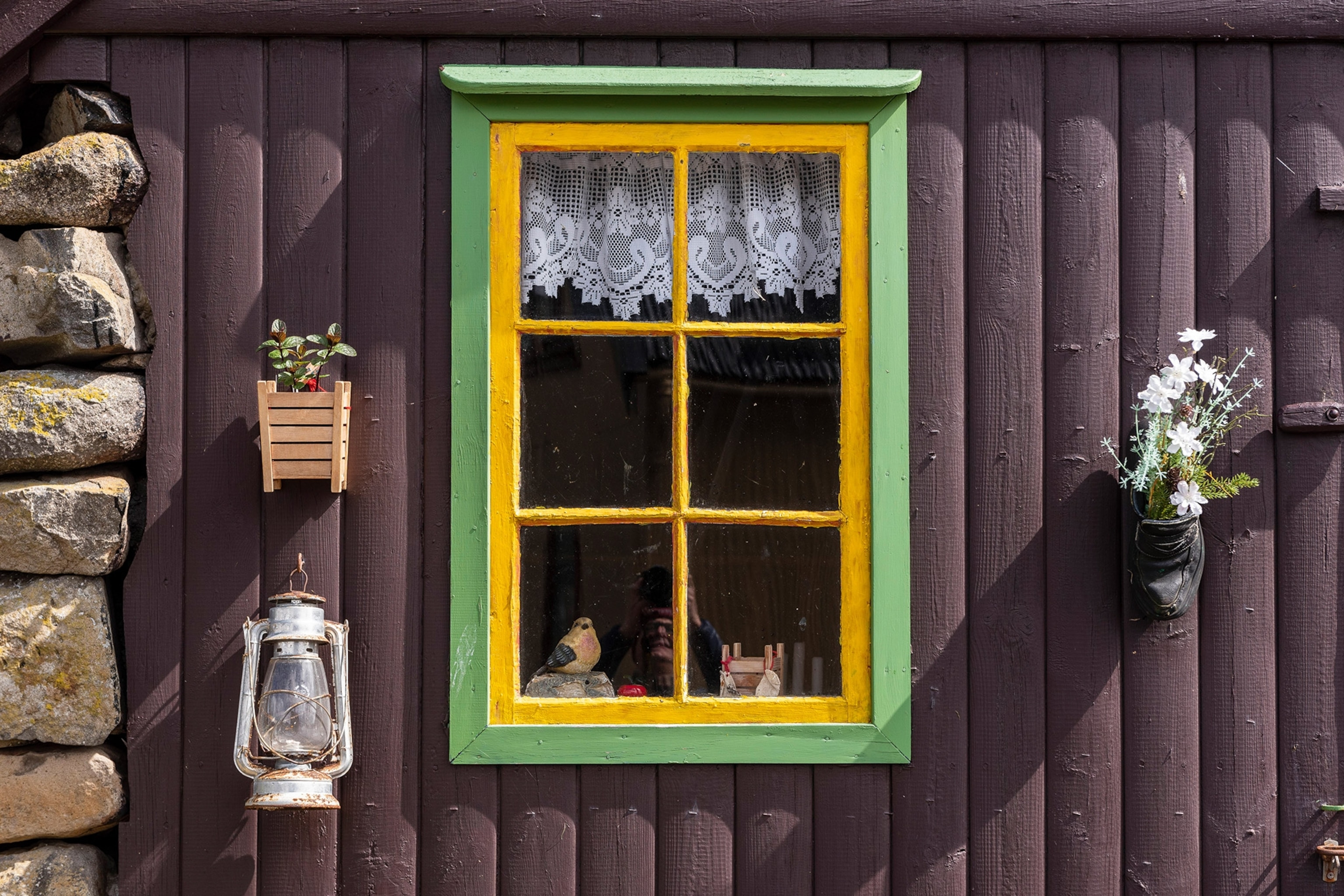 A fisherman's window sill in the Faroe Islands is painted pretty in bright green and yellow