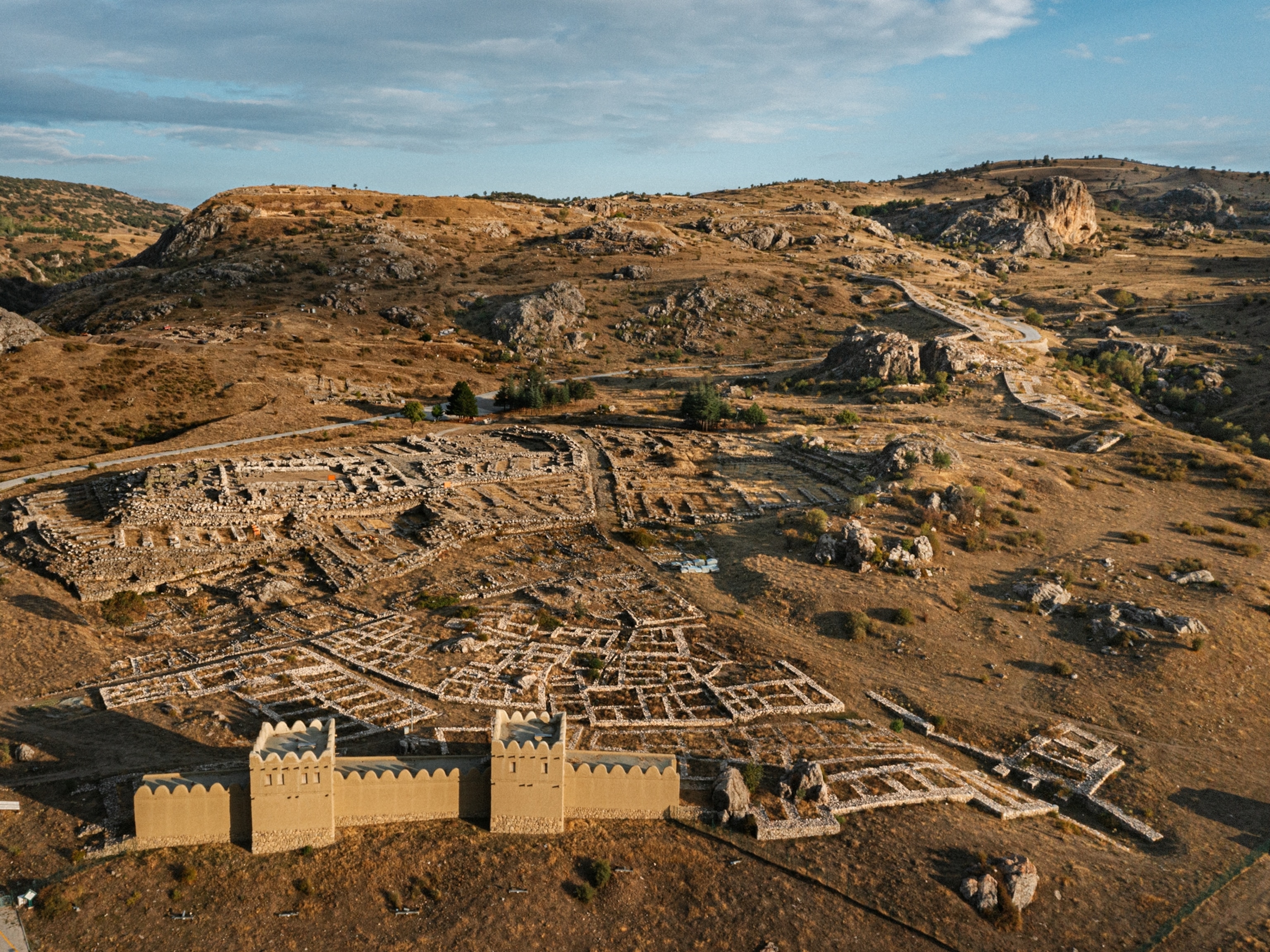 An aerial view of ancient capital among a hilly landscape.
