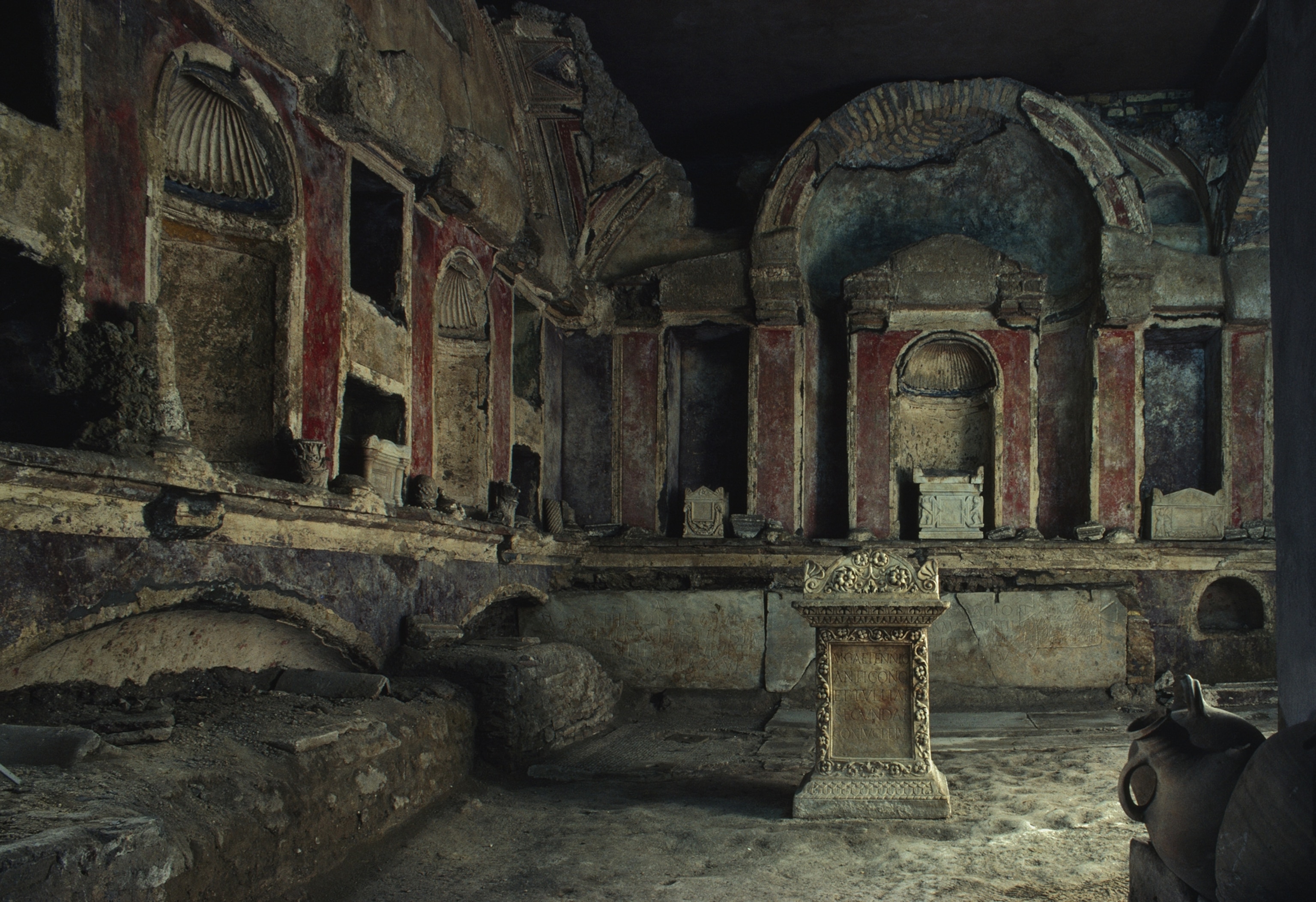 Underground ruins show various altars, sculptures, and tombs. The fainted paint on the walls are purple, blue, and red.