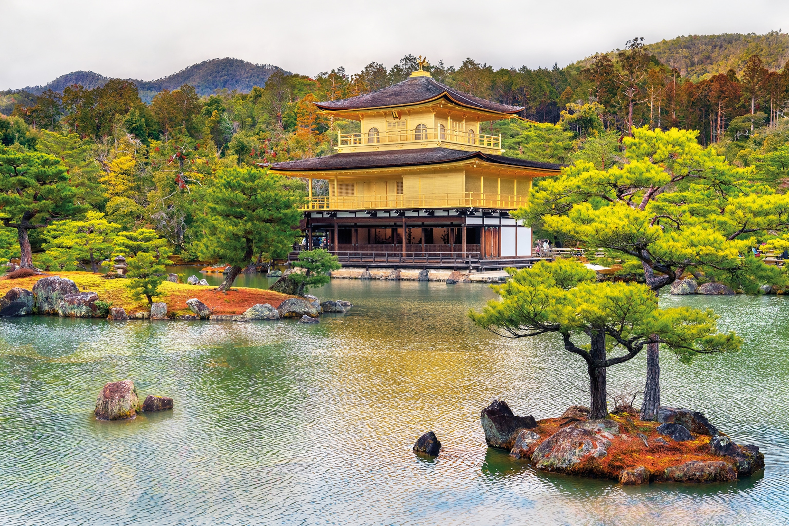 a japanese style building from across a lake