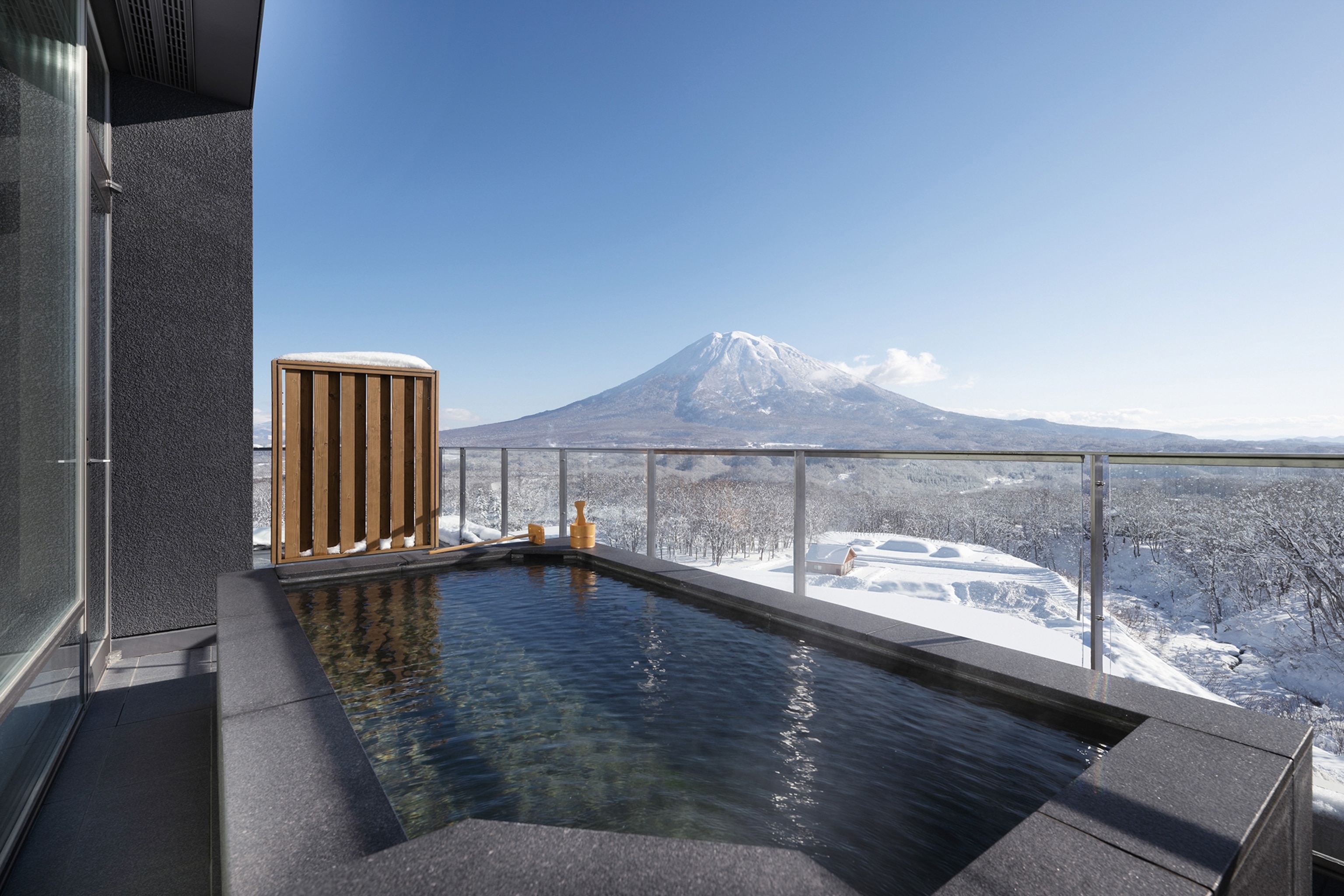 a balcony looking out onto snowy mountains